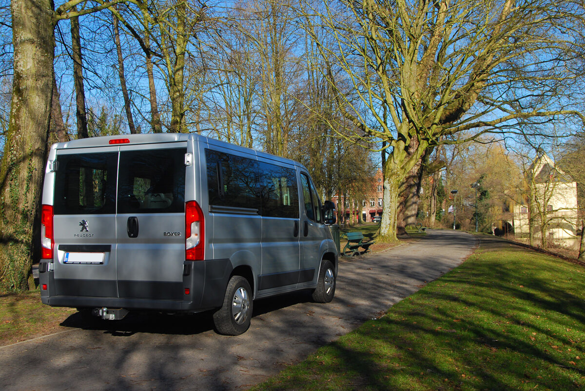 De achterzijde van een huur minibus met een grote kofferruimte voor 7 personen of meer. Deze foto is genomen in Brugge